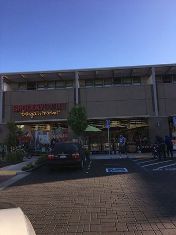 a car parked in front of a grocery store